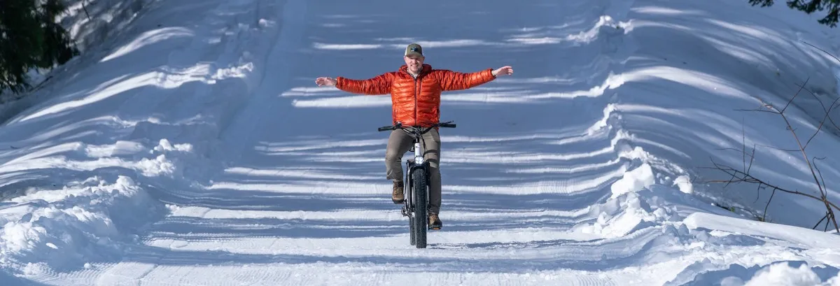 Man riding a fat bike in the snow.